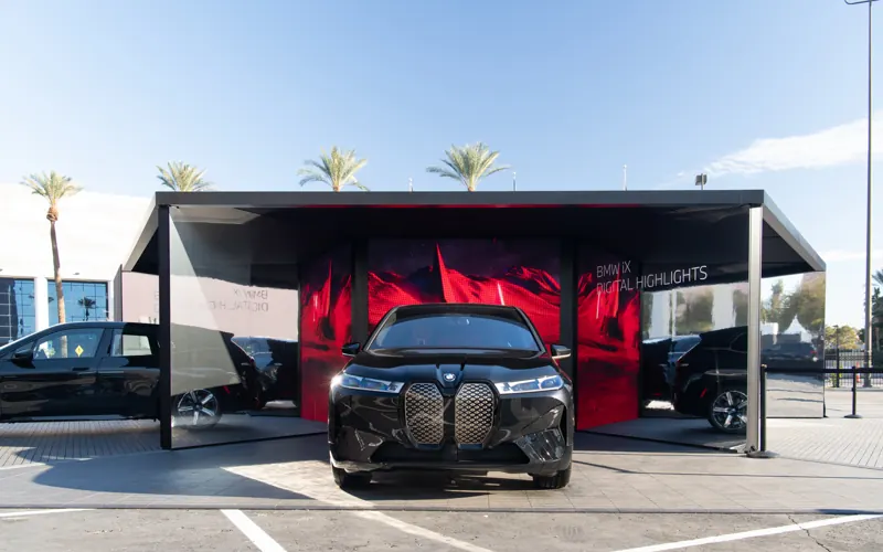 BMW pavilion at CES with cars under a black roof