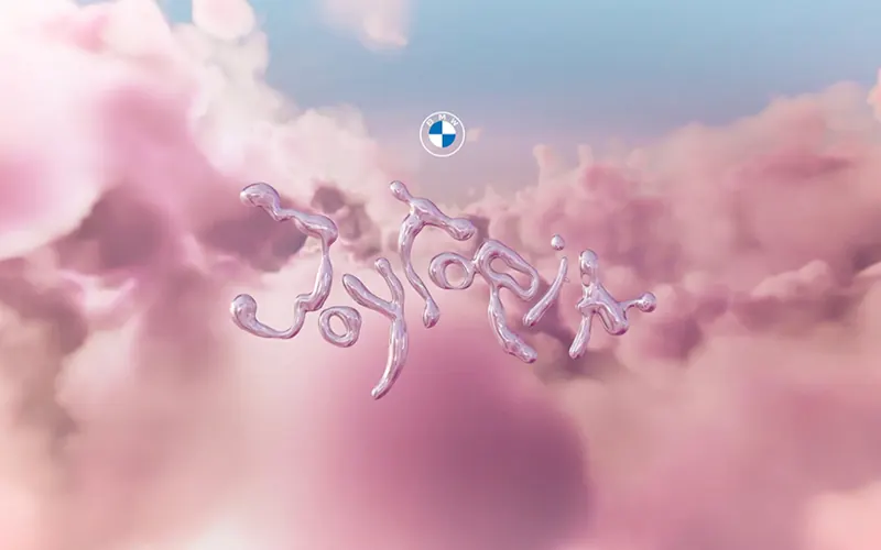 Chrome lettering Joytopia floating in pink clouds