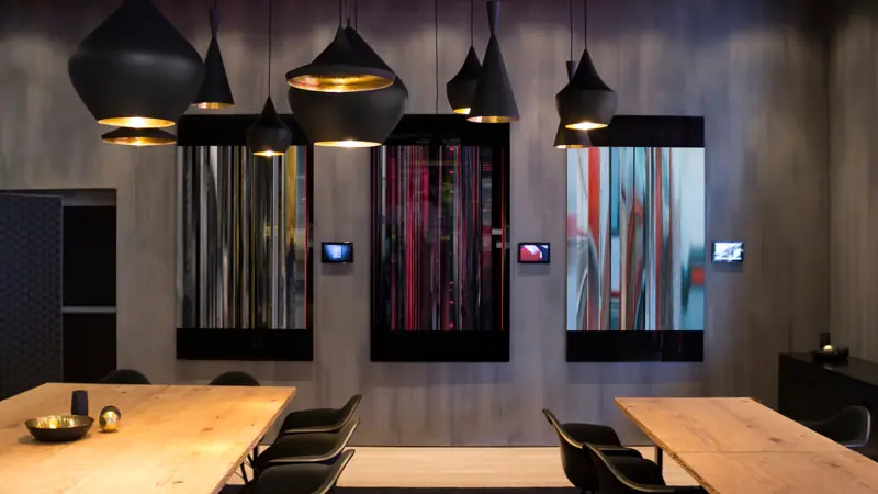 Dark room with lamps and glowing screens