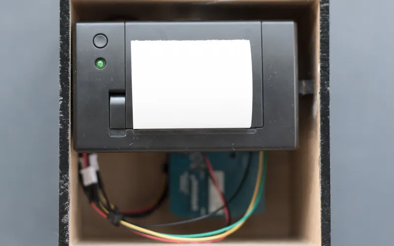 Thermal printer with exposed wiring inside a box