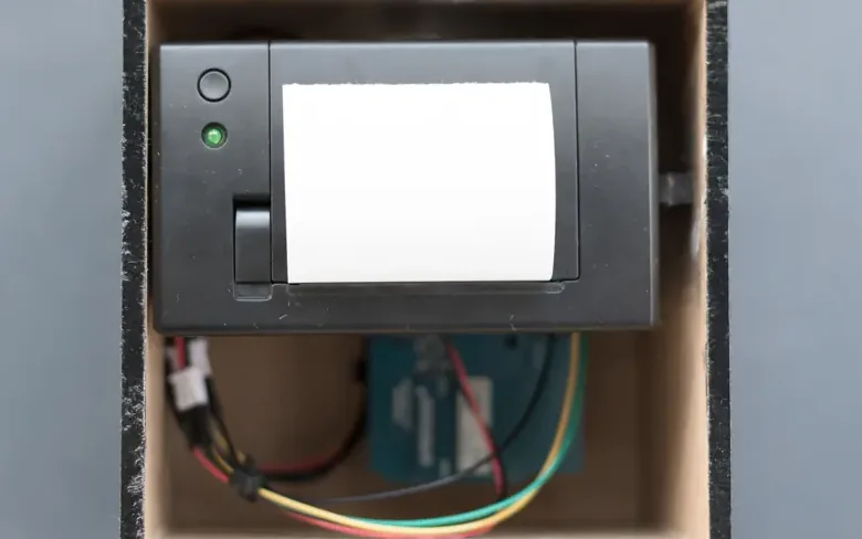Thermal printer with exposed wiring inside a box